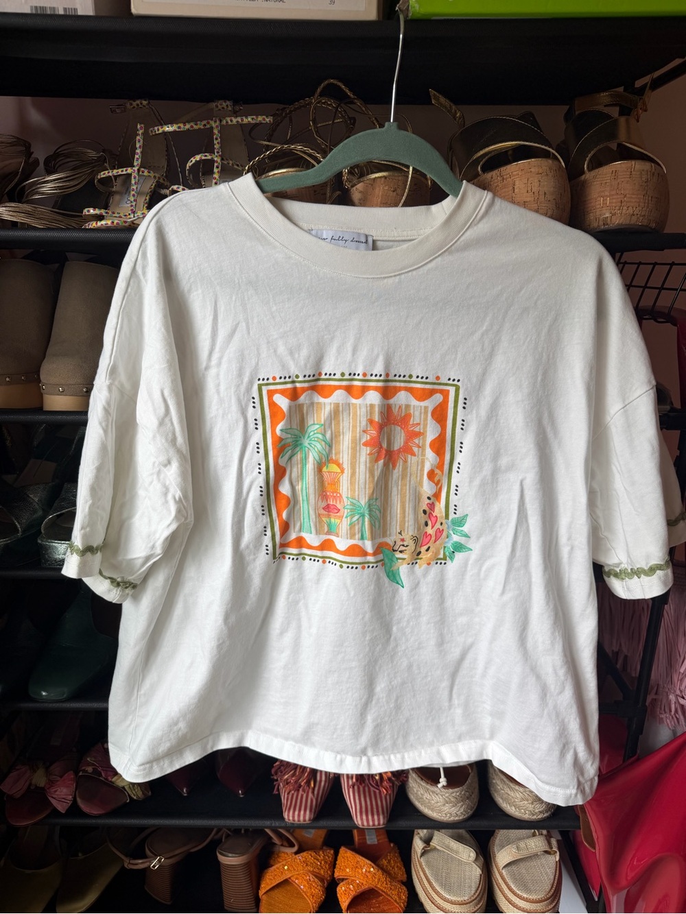 Never Fully Dressed Cream Short Sleeve Tee with Tropical Sunset Graphic